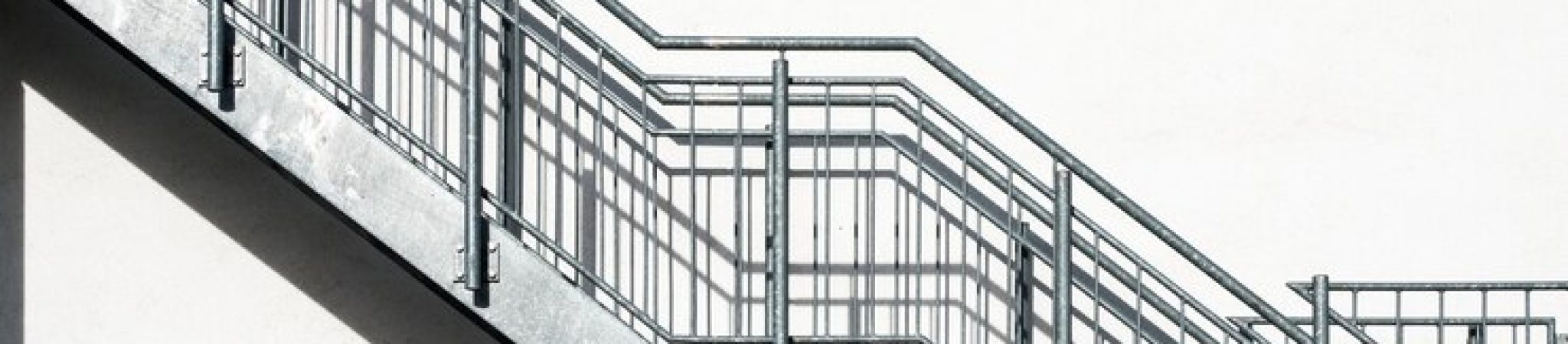 metal-stairs-white-building-wall_181624-25680